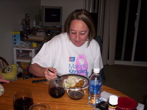 1989 Ford Bronco - A woman eats a meal at a table, wearing a shirt supporting 'Making Strides'.