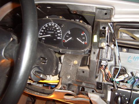 1997 Ford Ranger - The dashboard of a 1997 Ford Ranger is disassembled, revealing the instrument cluster and wiring harness.