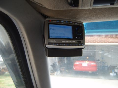 1997 Ford Ranger - Sirius Sportster satellite radio with phone number displayed on screen.