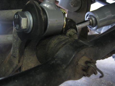 2001 Jeep Wrangler - Close-up view of suspension components, including a silver shock absorber and mounting hardware.