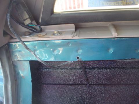 1996 Ford Bronco - Close-up of wiring and inner fender structure, likely from a vehicle's interior.