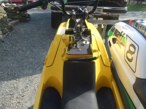 1998 Kawasaki JH1100-A4 1100 ZXi - Close-up view of a yellow jet ski's front section, with another jet ski visible to the right.