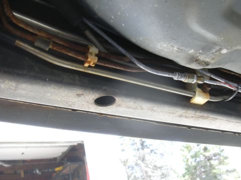 1996 Ford Crown Victoria - Close-up of undercarriage components, showing various lines and fasteners.