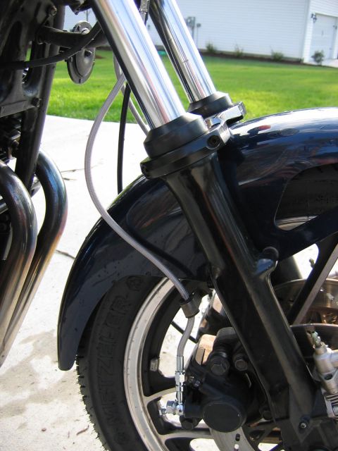 1985 Ford LTD Crown Victoria - The front section of a motorcycle is shown, including the suspension, fender, and wheel assembly.