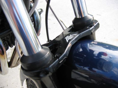 1985 Ford LTD Crown Victoria - Close-up of a motorcycle's front fork and fender assembly, showing the AIK branding.