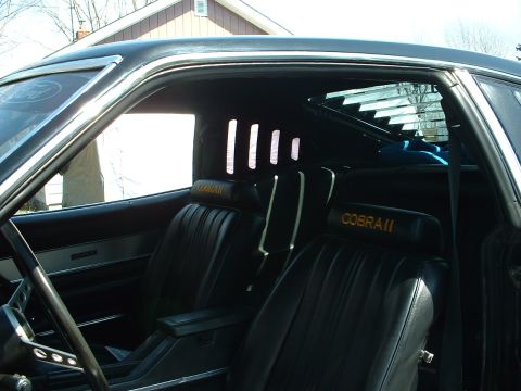 1978 Ford Mustang II - The interior of a 1978 Ford Mustang II Cobra II features black vinyl seats with embroidered headrests and rear window louvers.
