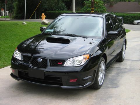 2007 Subaru Impreza - Black 2007 Subaru Impreza WRX STI shown from a 3/4 front angle. Red STI badges are visible on the grille and front bumper.