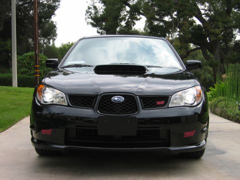 2007 Subaru Impreza - A black Subaru Impreza WRX STI is parked outside on a paved driveway, facing the camera.