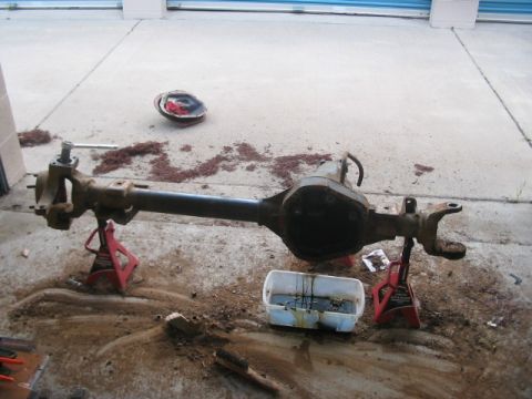1991 Ford Bronco - Dana 60 front axle assembly removed from a vehicle and placed on jack stands.