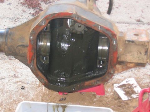 1991 Ford Bronco - Close-up of an open differential housing, showing internal components and dark fluid.