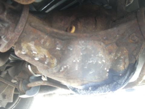 1996 Ford Crown Victoria - Underside view of heavily rusted rear differential and suspension components.
