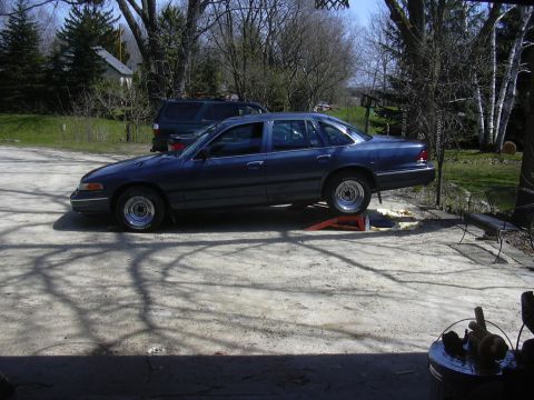 1996 Ford Crown Victoria - Dark blue 1996 Ford Crown Victoria is parked on ramps outdoors.
