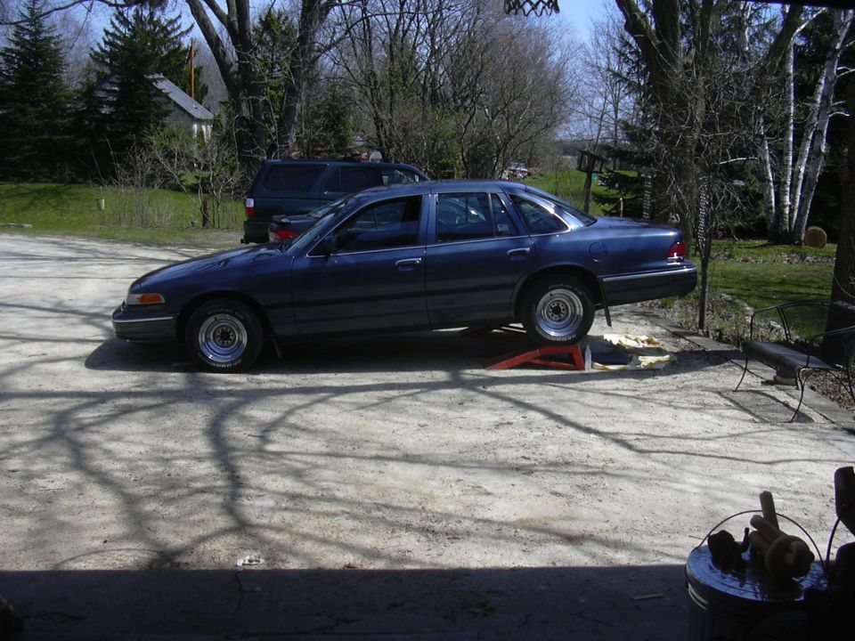 1996 Ford Crown Victoria on orange ramps in a driveway