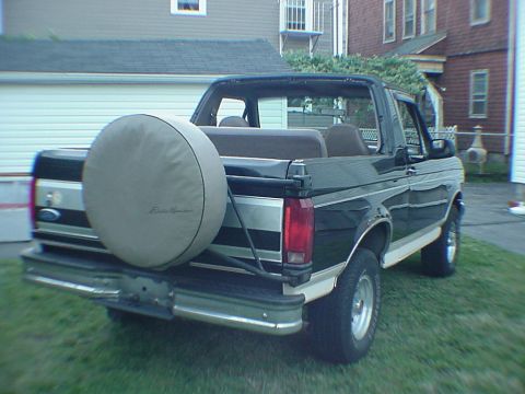 1993 Ford Bronco - Rear view of a 1993 Ford Bronco, showing its spare tire and removable top.