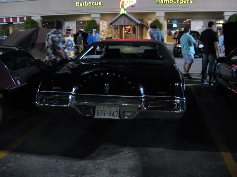 2000 Ford Crown Victoria - Rear view of a black 1972 Lincoln Continental Mark IV parked in front of a restaurant.