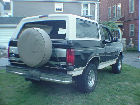 1993 Ford Bronco - This Ford Bronco is parked on a grassy lawn in front of a residential building.