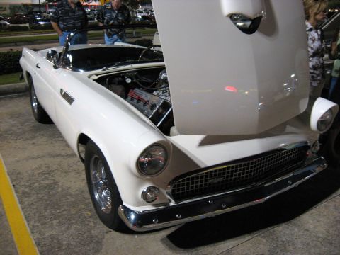 2000 Ford Crown Victoria - A white 1955 Ford Thunderbird convertible is displayed with its hood open, revealing the engine and chrome details.