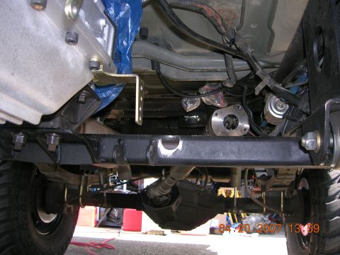 1996 Ford Bronco - A close-up view of the undercarriage reveals the complex mechanical components of the vehicle's drivetrain.