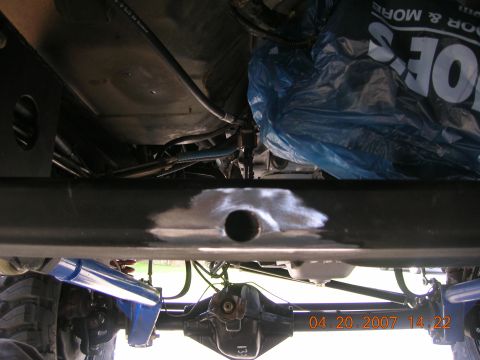 1996 Ford Bronco - The underside of a vehicle is shown, with visible suspension and drivetrain components.