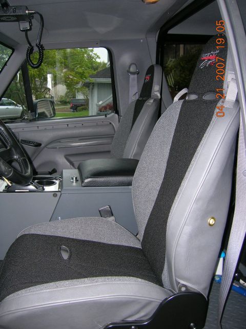 1996 Ford Bronco - The interior of a 1996 Ford Bronco is visible, grey seats with black inserts and a center console.