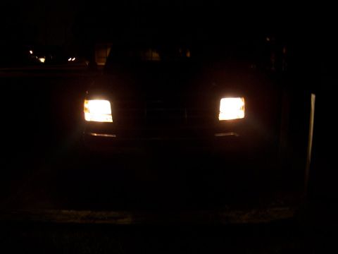 1995 Ford Bronco - The front of a 1992 Ford Bronco is visible at night, illuminated by its headlights.
