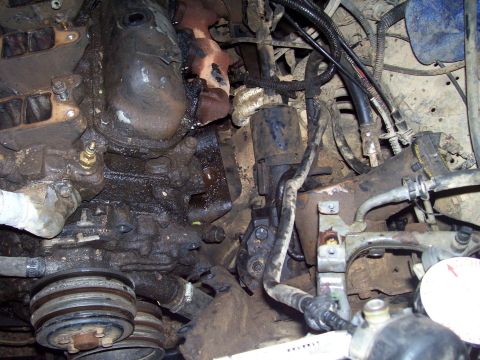 1989 Ford Bronco II - Close-up view of an engine bay, focusing on the starter motor and associated components.