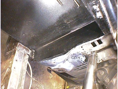 1960 Ford Falcon - Close-up view of underbody frame repair work, showing welded sections and structural support.