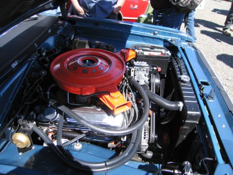 1991 Ford LTD Crown Victoria - Close-up of a V8 engine in a blue vehicle, a prominent red air filter housing.