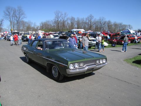 1991 Ford LTD Crown Victoria - A green sedan with a distinctive grille is displayed at a car show event.