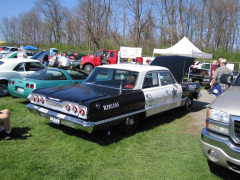 1991 Ford LTD Crown Victoria - A vintage police car with "CCPD" and "RH6505" visible on its side is parked on grass.