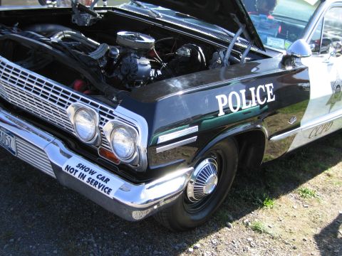 1991 Ford LTD Crown Victoria - This police car has its hood open, revealing the engine compartment and a "SHOW CAR NOT IN SERVICE" bumper sticker.