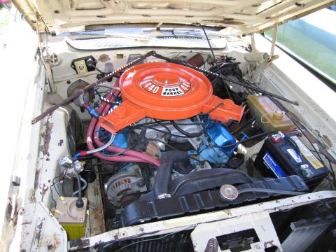 1991 Ford LTD Crown Victoria - The engine bay of a classic car, a large V8 engine with a prominent orange air filter housing.