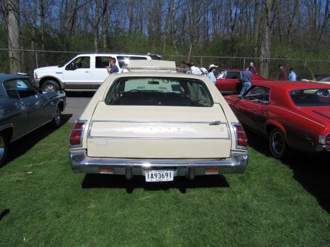 1991 Ford LTD Crown Victoria - A beige station wagon is parked on grass with other vehicles visible in the background.