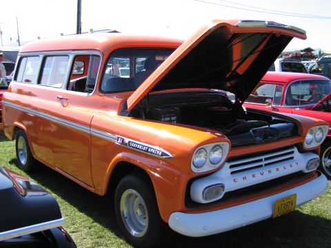 1991 Ford LTD Crown Victoria - This vintage Chevrolet Suburban, likely from the mid-1950s, is displayed with its hood open at an outdoor event.