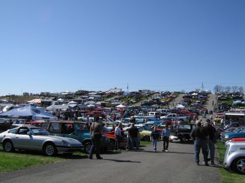 1991 Ford LTD Crown Victoria - A large outdoor gathering of cars and people on a sunny day.