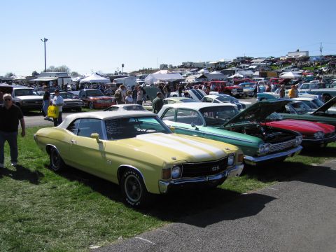 1991 Ford LTD Crown Victoria - A sunny day at a car show features a yellow 1970 Chevelle SS convertible among many other classic vehicles.