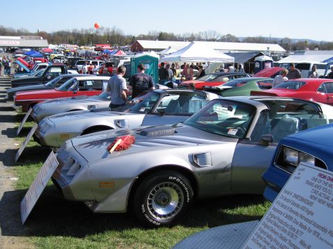 1991 Ford LTD Crown Victoria - A row of classic cars are displayed at an outdoor event under a clear sky.