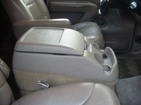 1993 Ford Bronco - Interior view of a 1993 Ford Bronco's center console, showing cup holders and storage.
