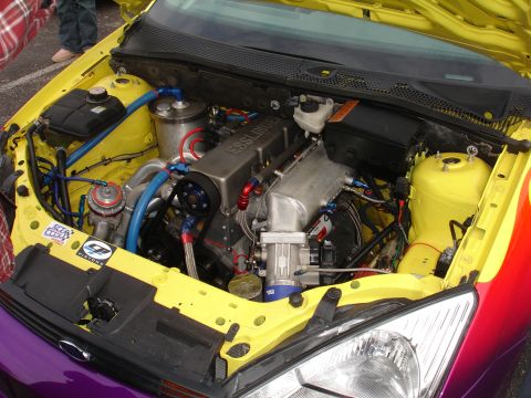1993 Ford Taurus - Customized engine bay an Esslinger engine, with yellow paint and a purple and red fender visible.