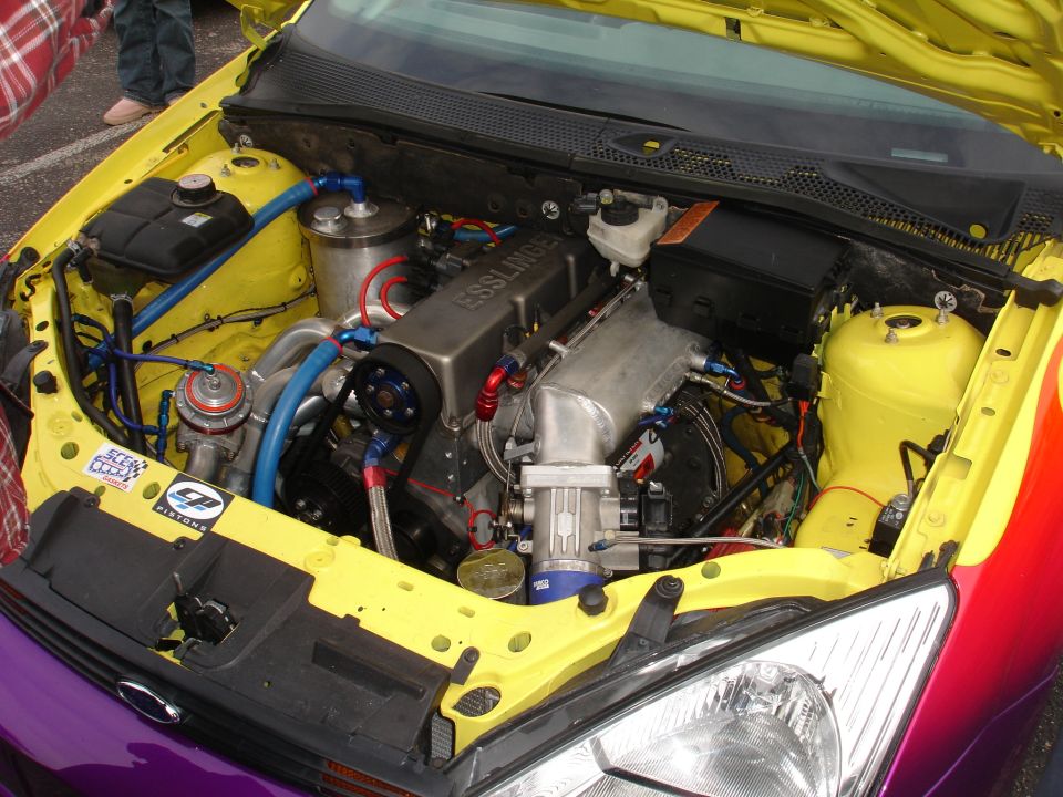 Yellow engine bay with custom Esslinger engine and purple/red fender