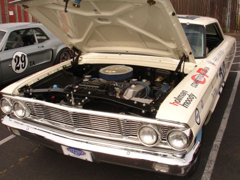 1993 Ford Taurus - A vintage Ford Galaxie, likely from the early 1960s, is displayed with its hood open, revealing the engine bay.