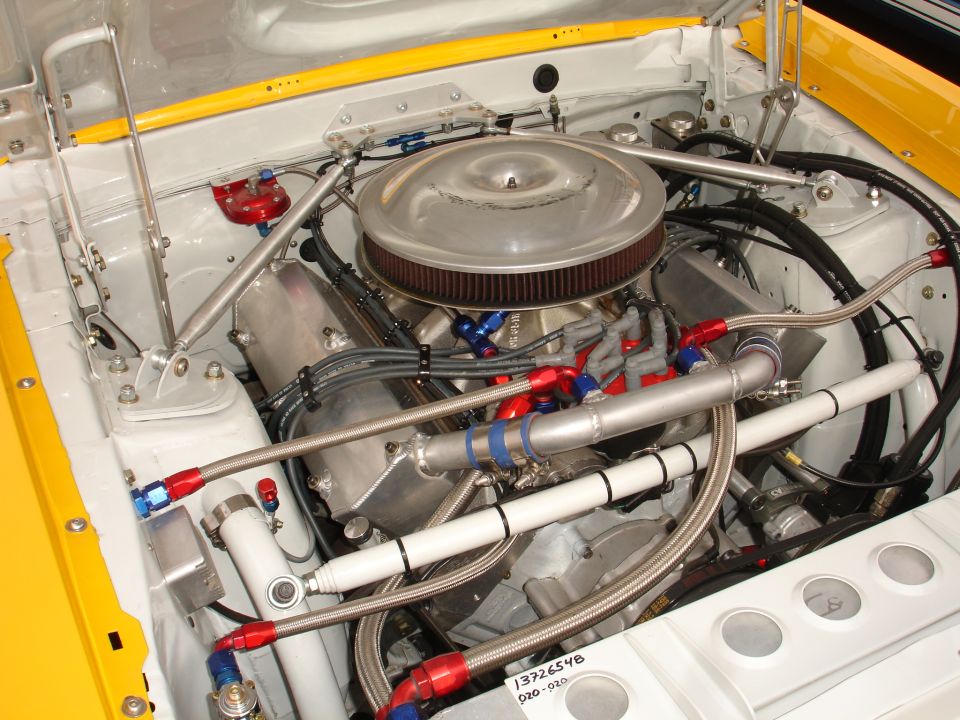 Engine bay with V8 engine, chrome air cleaner, and yellow accents