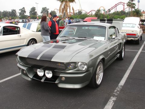 1993 Ford Taurus - A silver 1967 Shelby GT500 Mustang is parked at a car show with other vehicles visible.