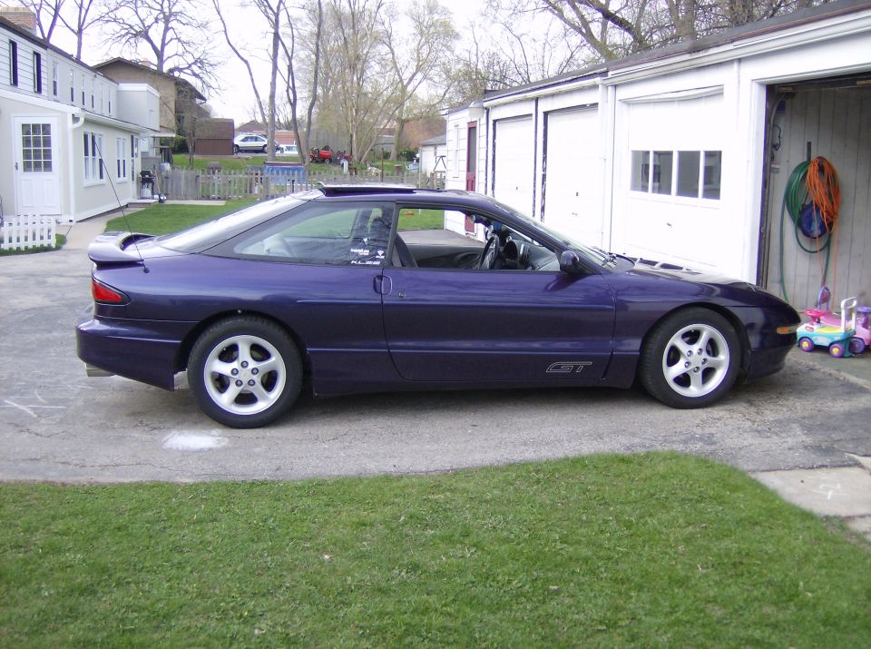 Purple 1996 Ford Probe GT coupe parked in driveway, side view