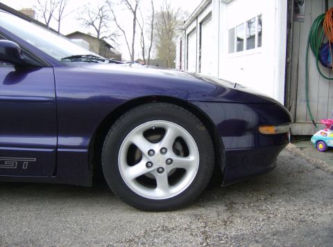 1996 Ford Probe - Front quarter of a purple Ford Probe GT showing the alloy wheel and GT badging, parked by a garage