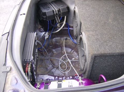 1996 Ford Probe - The trunk of a car is filled with audio equipment, including subwoofers and an amplifier.
