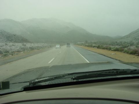 1994 Ford Bronco - The view from the windshield shows a hazy day on the highway with other vehicles ahead.