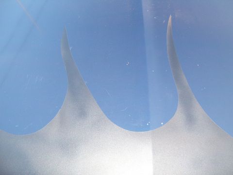 1993 Ford Bronco - Close-up of silver flame decals on a blue surface, possibly a vehicle.