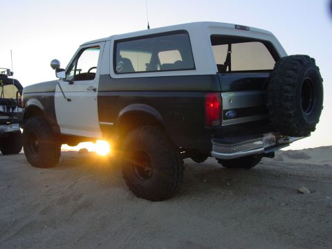 1994 Ford Bronco - This 1994 Ford Bronco, seen from the rear, features a two-tone paint scheme and a spare tire carrier.
