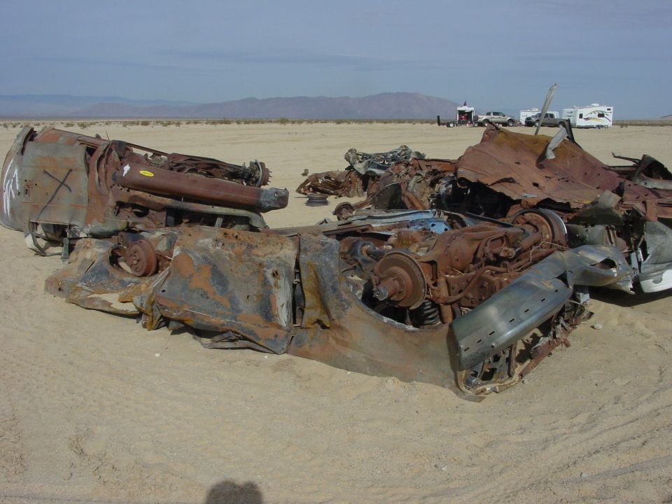 wrecked vehicle chassis in desert
